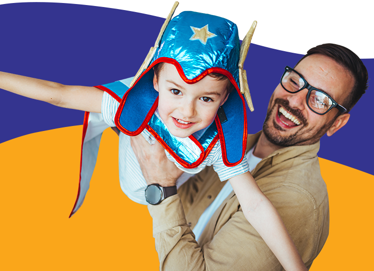 Father holding son with a hero costume