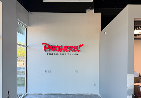 Partners Federal Credit Union logo on wall
